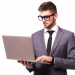 Handsome businessman with laptop isolated on white background